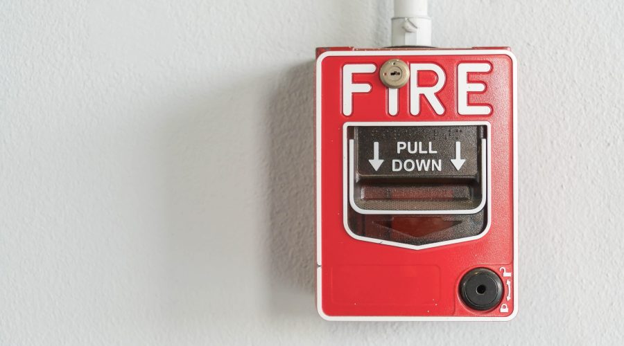 Fire alarm switch on white wall